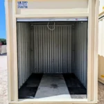 Interior of 10 foot beige container with open doors and wood floor