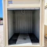 Interior of 10 foot beige container with open doors and wood floor